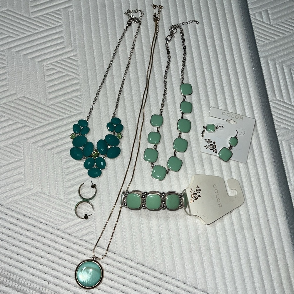 Three necklaces one bracelet and two pairs of earrings some new with tags